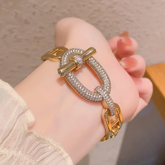 Gold and rhinestone chain novelty bracelet by MyClosetAid on wrist with toggle clasp