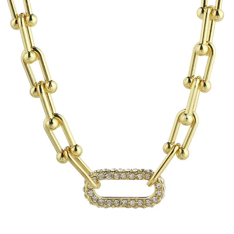 Gold chain necklace with diamond-studded link showcasing diamond jewelry engagement rings style