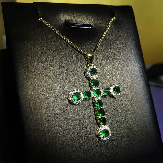 MyClosetAid natural emerald cross necklace with green gemstones and gold chain on black display